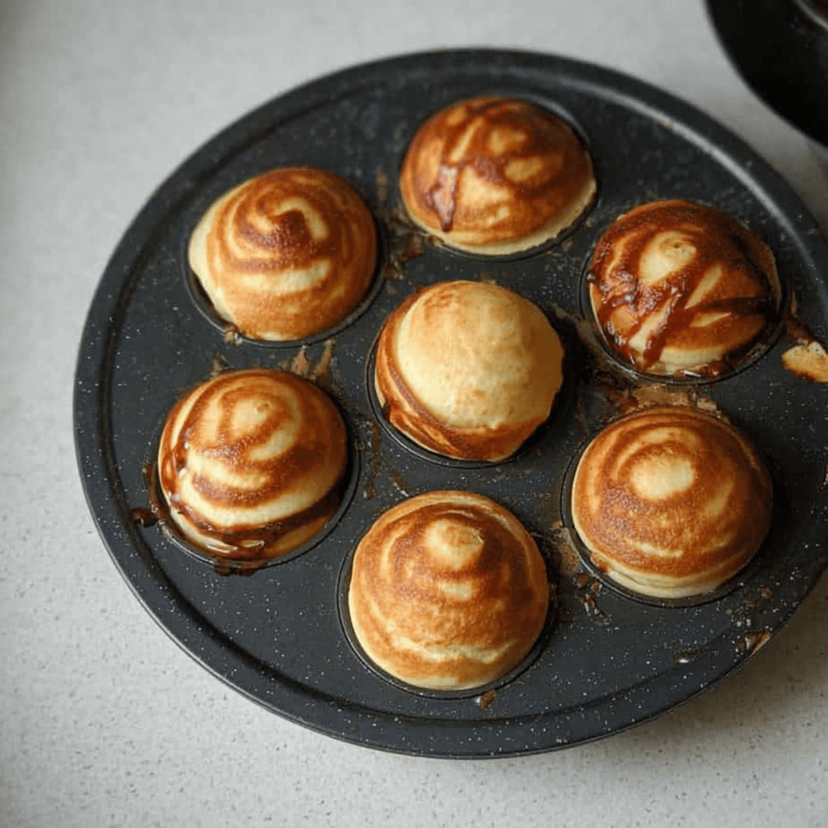 How to Make Fluffy Nutella Pancake Balls (With or Without a Special Pan!) 13 flipping Nutella pancake balls in Aebleskiver pan